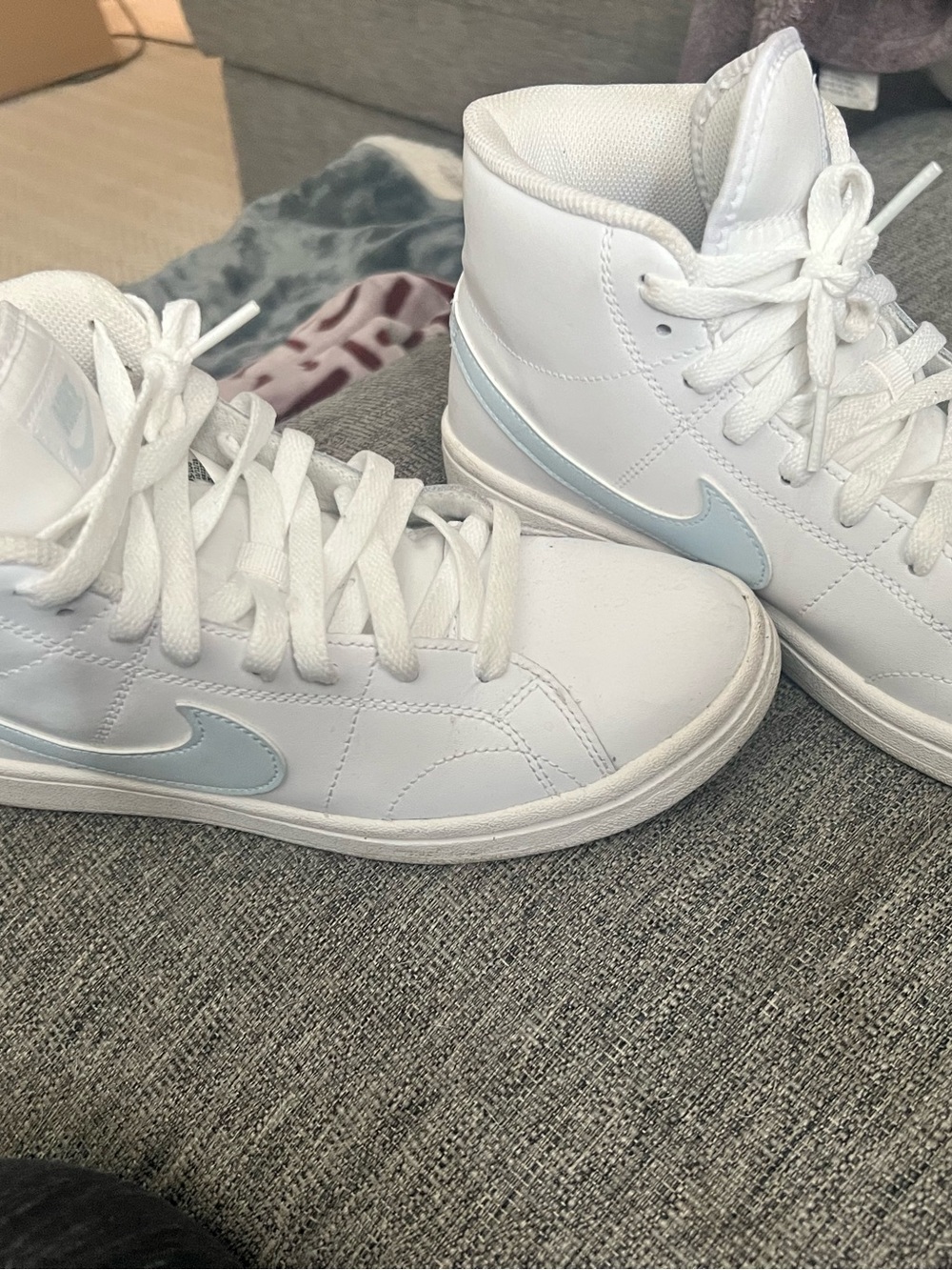 Nike Women's White High-Top Sneakers with Light Blue Swoosh